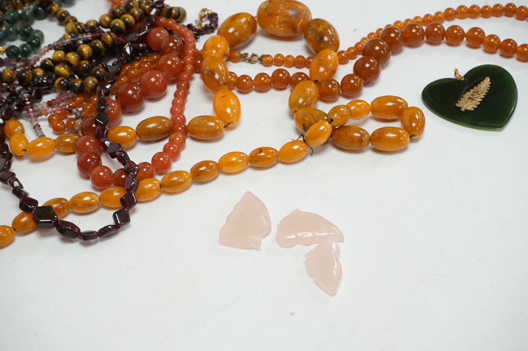 Nine assorted necklaces, including graduated cultured pearl, with 15ct and enamel clasp, 38cm, moss agate, garnet and tiger's eye quartz, etc and two other items, one a.f. Condition - poor to fair to good